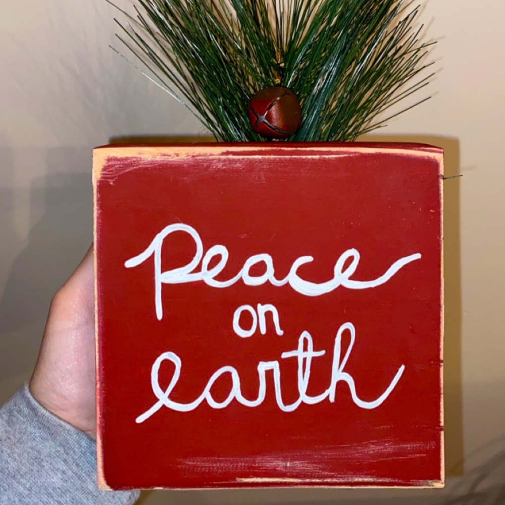 Handcrafted and one of a kind! Peace On Earth wooden sign with greenery.